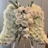 White bell-shaped floral arrangement of chrysanthemums with clustered ivory roses in the center