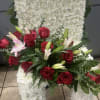 White floral standing spray with red roses and pink lilies