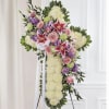 Standing floral cross with pink roses, lilies, and white blooms