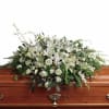 White floral casket spray with roses and lilies