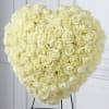 Large heart-shaped bouquet of cream roses on a stand