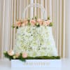 Elevate your floral gifting game with our "Peachy Chic Purse" flower arrangement!