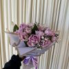 Woven with a captivating mix of deep purple tulips, this enchanting bouquet
