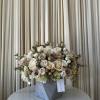 Cream and blush rose arrangement in a gray geometric vase