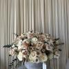 Large cream and blush rose arrangement in a gray urn vase