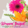 Bright pink gerbera and orange lily wrapped as a bouquet