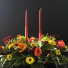 Hues of orange, greens, and yellows make this centerpiece a joyful complement