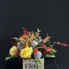 Yellow roses in a Noel box with red accents and pinecones