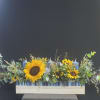 This radiant floral arrangement brings together the warmth of golden sunflowers, the