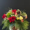 A stone pot with a snowy landscape, red roses, white spray roses