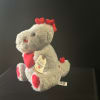 Plush gray dinosaur with red hearts and a hanging tag