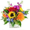 Bright mixed bouquet with sunflower, red rose, and orange gerbera in a clear glass cube vase