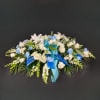 Blue carnations and/or mums are surrounded by a mix of white flowers