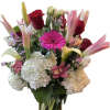 Mixed bouquet of roses, lilies, gerbera daisies, and hydrangeas in a glass vase