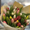 Bouquet of multicolored tulips wrapped in paper