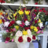 Mixed bouquet of roses, lilies, and hydrangeas in a white vase