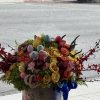 Colorful bouquet of roses with pastel Easter eggs in a box