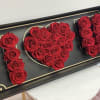 Red roses arranged in a black box to spell "I ♥ U"