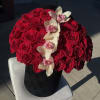 Red rose arrangement with white orchids in a black hatbox