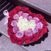 Heart-shaped box filled with red, pink, and white roses