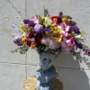 Colorful mixed bouquet arranged in a blue bust vase