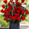 Bouquet of red roses in a black box vase