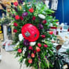 Large floral arrangement with red roses and a red balloon centerpiece