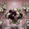 A stunning arrangement of mixed flowers, including dark purple, white, and lavender