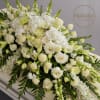  Luxurious casket spray overflowing with an array of white and ivory