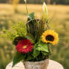 Basket arrangement with a red gerbera daisy and yellow sunflower