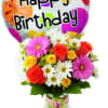 Birthday balloon above a colorful bouquet in a glass vase