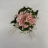 Pink floral corsage with ribbon and pins