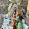 Gift basket wrapped in clear cellophane with ribbon and assorted bath items