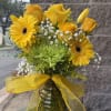 Sunny yellow gerbera daisies and roses take center stage in this cheerful