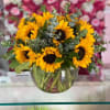 Bouquet of yellow sunflowers in a clear glass vase