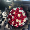 Bouquet of red and white roses wrapped in black paper
