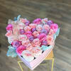 Heart-shaped box of pink and lavender roses with a ribbon bow