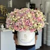 Large pastel bouquet in a white hatbox with pink and lavender flowers