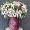 Large pastel bouquet of roses and lisianthus in a pink hatbox