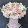 Pink and white roses with orchids in a pink hatbox