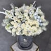 White rose bouquet with silver accents in a gray hatbox