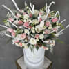 Pink and white roses in a white hatbox with frosted winter accents