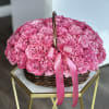Basket of pink roses with a pink ribbon bow