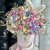 Pastel bouquet in a pink hatbox with plush bunny ears