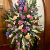 Large standing floral spray with pink, purple, and white flowers