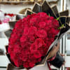 Large bouquet of red roses wrapped in black paper