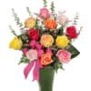 Colorful rose bouquet in a green vase with a pink ribbon