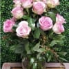 Pink roses arranged in a clear glass vase