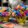 Rainbow flower arrangements in yellow smiley-face mugs