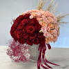 Large bouquet of red and blush roses in a silver vase